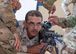 A U.S. Army Soldier, with Military Engagement Team-Jordan, 158th Maneuver Enhancement Brigade, Arizona Army National Guard, adjusts the scope of a Jordan Armed Forces-Arab Army (JAF) snipers’ rifle during a Sniper Subject Matter Expert Exchange at a base outside Amman, Jordan, in October 2019.