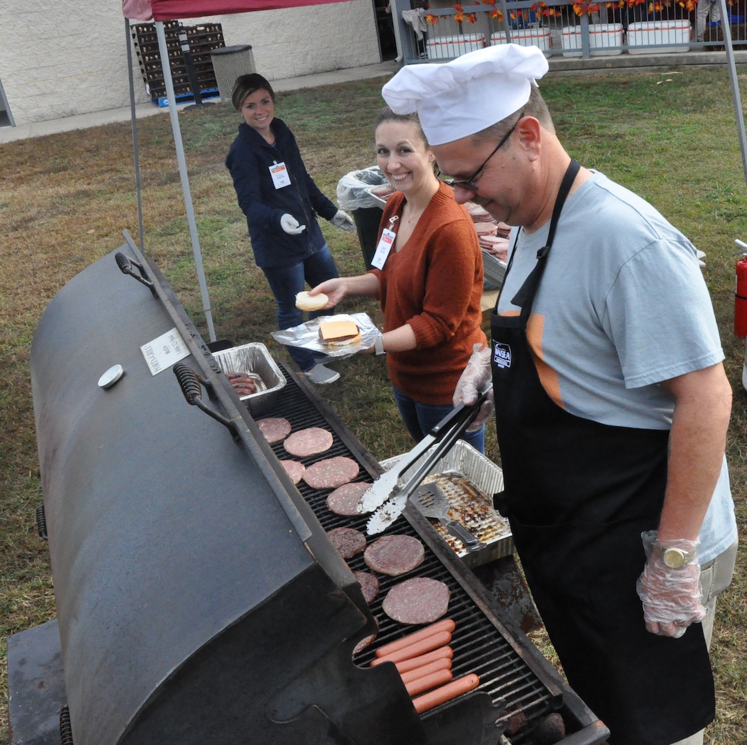 IMAGE: DAHLGREN, Va. (Oct. 30, 2019) – Naval Surface Warfare Center Dahlgren Division Chief of Staff, Chuck Campbell, helps prepare burgers and hot dogs before the start of the 2019 command picnic. (U.S. Navy photo/Released)