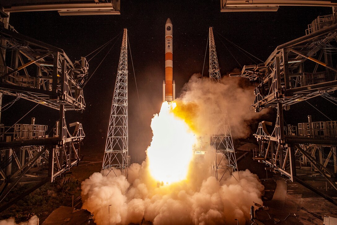 A rocket takes off from a launch complex.