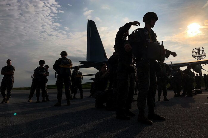 U.S. Marines with 3rd Reconnaissance Battalion, 3rd Marine Division prepare and inspect their equipment during parachute operations out of a KC-130 Hercules on Ie Shima, Okinawa, Japan, Oct. 28-30, 2019.  This combined training included Marines from 3rd Transportation Support Battalion, 3rd Marine Logistics Group, as well as support from Marine Aerial Refueler Transport Squadron 152 and Marine Light Attack Helicopter Squadron 169, 1st Marine Aircraft Wing.  This military training ensures the Marines from III Marine Expeditionary Force are constantly trained and ready to provide aerial delivery of personnel or equipment wherever needed, quickly and effectively.  The U.S. military training conducted in the INDOPACIFIC area also provides security to the region, to include our Japanese Allies.