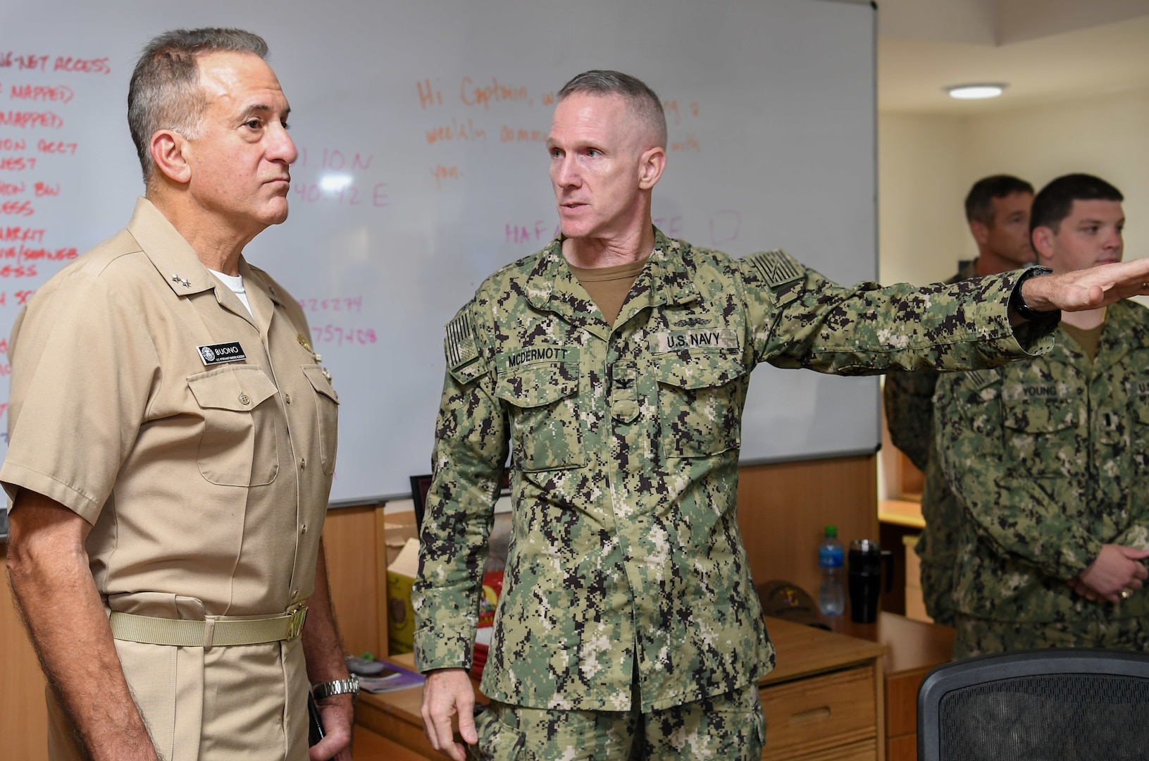 Capt. Charles McDermott, center, gives a tour of the Naval Coordination and Guidance for Shipping (NCAGS) facilities to Rear Adm. Jack Buono, the Superintendent of the U.S. Merchant Marine Academy. The U.S. Naval Forces Central Command NCAGS team has recently amplified their support to the region in support of Operation Sentinel, a multinational maritime security effort designed to increase surveillance of key waterways in the Middle East to ensure freedom of navigation. (U.S. Navy photo by Mass Communication Specialist 3rd Class Dawson Roth/Released)