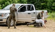 Members of the Polish Territorial Defense Forces receive training in checkpoint vehicle clearing techniques from members of West Virginia Army National Guard (WVARNG) Special Forces during Ridge Runner 19-02, June 24, 2019, in West Virginia. Ridge Runner is a WVARNG training program that provides various National Guard, active duty, and North Atlantic Treaty Organization (NATO) ally nation armed forces with training in irregular and asymmetrical warfare tactics and operations. (U.S. Army National Guard photo illustration by Edwin Wriston.) (This photo has been altered for security purposes by blurring out faces.)