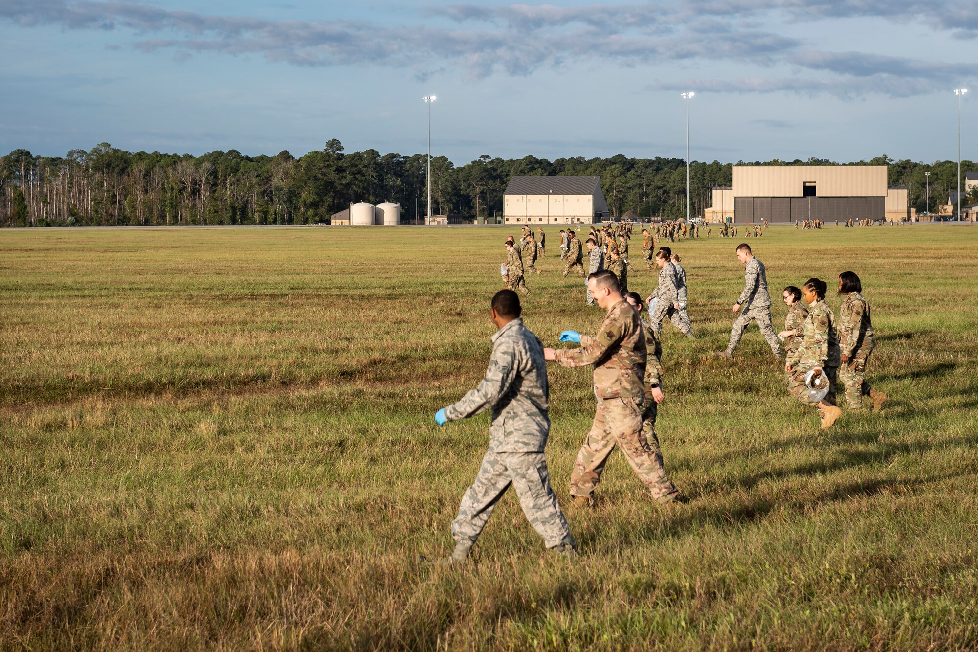 A photo of Airmen conducting a foreign object debris walk across the airfield