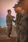 San Diego, California – Sergeant. Hector Lomeli a Senior Drill Instructor with Echo Company Platoon 2115, 2nd Recruit Training Battalion, gives the Eagle, Globe to his Marines after completing the Crucible at Marine Corps Base Camp Pendleton, California Oct. 24.