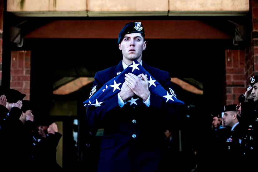 U.S. Air Force Staff Sgt. Alec Ducsay, 87th Security Forces military working dog handler, exits the McGuire Chapel as a final salute is rendered in honor of his MWD Robby during a memorial ceremony on Joint Base McGuire-Dix-Lakehurst, New Jersey, Nov. 1, 2019. Robby was born Jan. 9, 2009 and entered the Air Force on June 24, 2011. She served her country performing as a patrol explosive detector dog in Saudi Arabia, Kyrgyzstan and Kuwait.