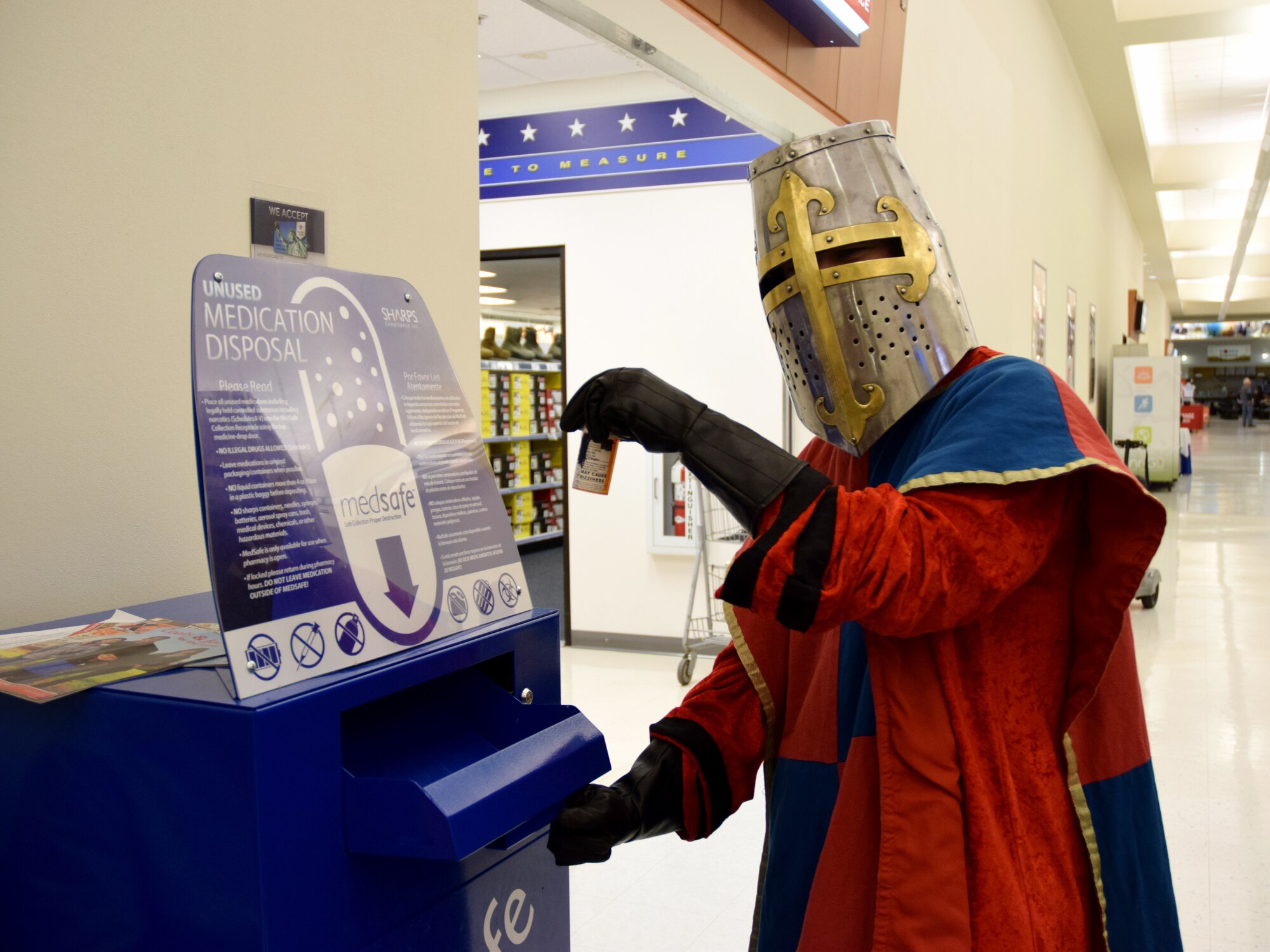 Mike the Knight disposes of medication in a MedSafe Oct. 23, 2019, on Peterson Air Force Base, Colorado. These MedSafes allow anyone with access to Peterson to safely and securely dispose of unused, unwanted or expired medication year-round. (U.S. Air Force photo by Griffin Swartzell)