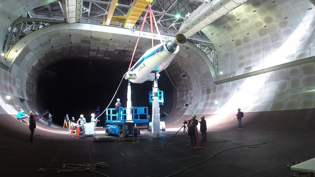 Arnold Engineering Development Complex (AEDC) team members lower the NASA/Army Tiltrotor Test Rig (TTR) into the 40- by 80-foot wind tunnel in the AEDC National Full-Scale Aerodynamics Complex (NFAC) at Moffett Field in Mountain View, California. The TTR was developed to study advanced tiltrotors and develop databases for design code validation. NFAC craftsmen not only install test articles in the facility wind tunnels, but they also operate and maintain the wind tunnels. (U.S. Air Force photo)