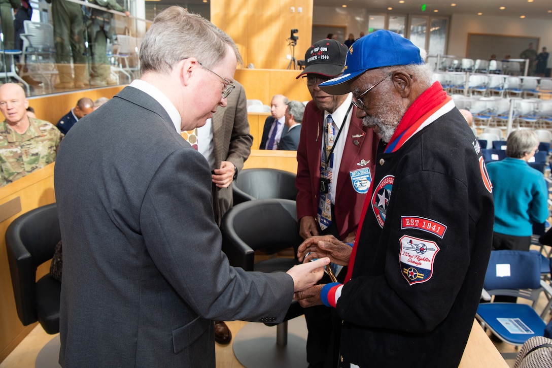 Deputy Defense Secretary David L. Norquist meets with two Tuskegee Airmen.