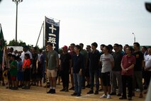 U.S. Marines with 4th Marine Regiment, 3rd Marine Division, and Okinawa residents stand for the playing of the Japanese National Anthem during the opening ceremony for the 46th Annual Henoko District Citizen’s Track and Field Meet Sports Day in Henoko, Okinawa, Japan, Nov. 3, 2019. Personnel from Camp Schwab have been included in the track and field meet since 1973 and will carry on the tradition of good will and togetherness with the people of Henoko. (U.S. Marine Corps photo by Cpl. Josue Marquez)