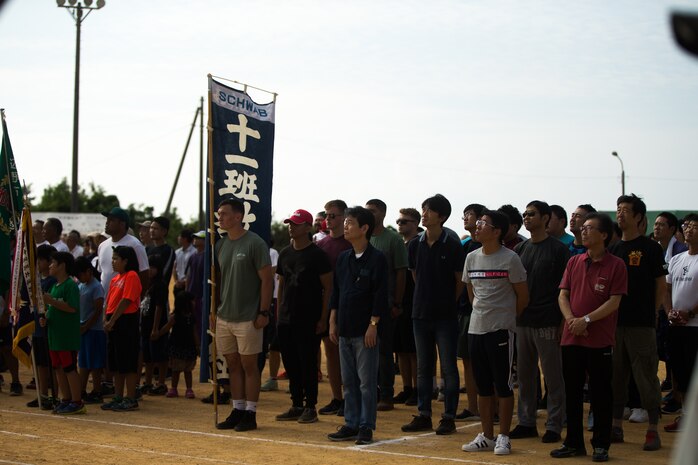 U.S. Marines with 4th Marine Regiment, 3rd Marine Division, and Okinawa residents stand for the playing of the Japanese National Anthem during the opening ceremony for the 46th Annual Henoko District Citizen’s Track and Field Meet Sports Day in Henoko, Okinawa, Japan, Nov. 3, 2019. Personnel from Camp Schwab have been included in the track and field meet since 1973 and will carry on the tradition of good will and togetherness with the people of Henoko. (U.S. Marine Corps photo by Cpl. Josue Marquez)