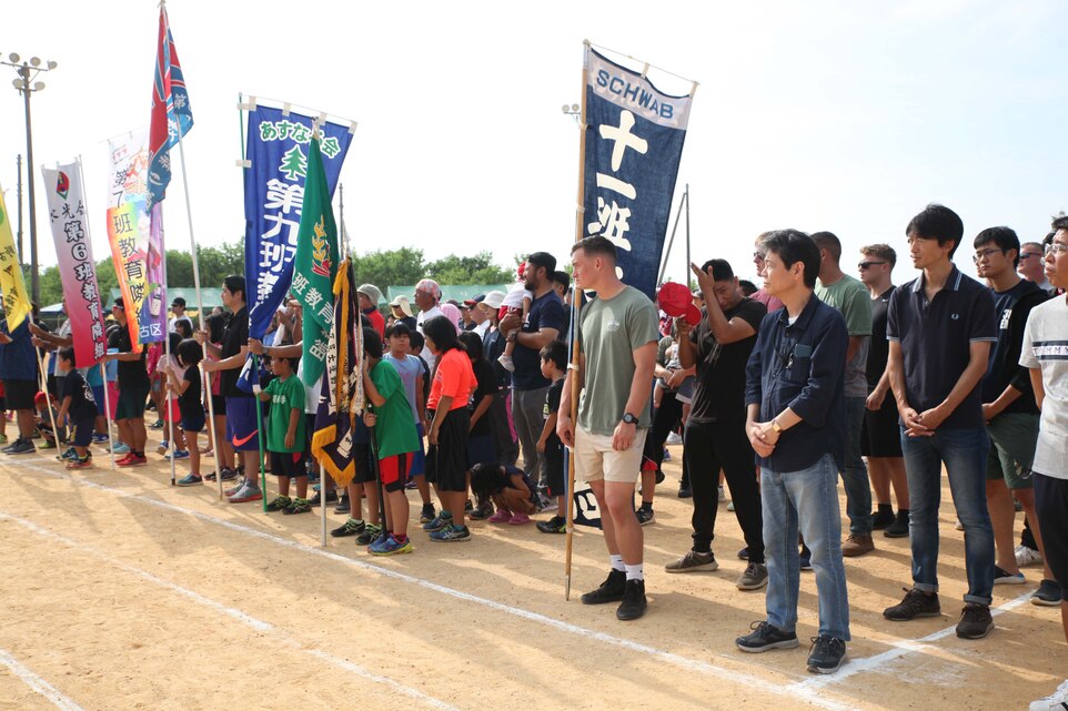 The Marines from Camp Schwab and the members of Okinawa Defense Bureau line up with local residents in the opening ceremony of the 46th Henoko Sports Festival held at Henoko athletic Nov. 3, 2019, Camp Schwab and Okinawa Defense Bureau were invited to participate in the event.