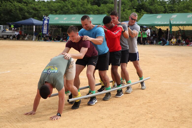 Marines participating in centipede race struggle to run as a team during the 46th Henoko Sports Festival at Henoko athletic field Nov. 3, 2019, Camp Schwab and Okinawa Defense Bureau were invited to participate in the event.