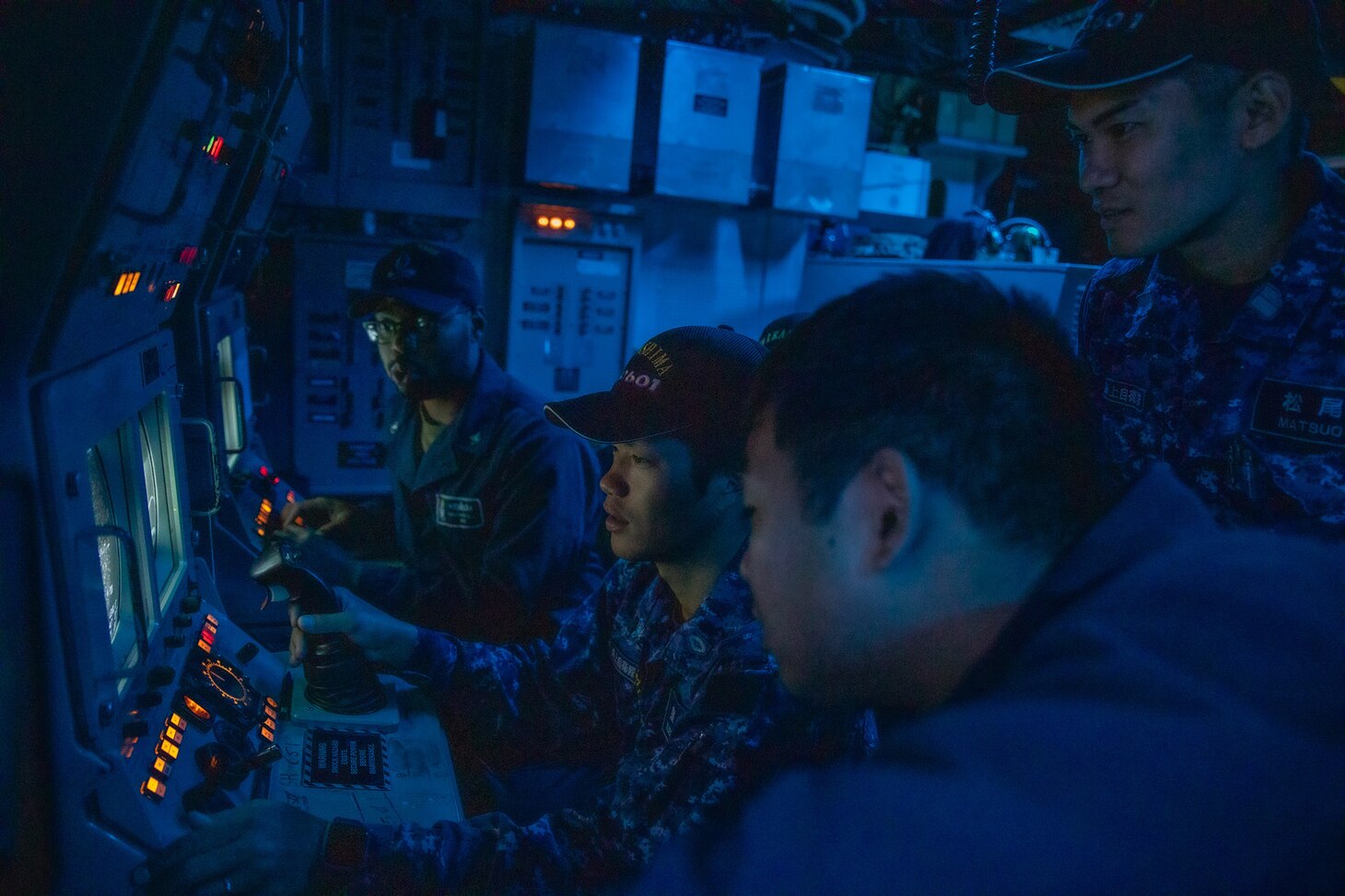 191101-N-AD347-0141 SASEBO, Japan (November 01, 2019) Japanese Maritime Self-Defense Force sailors from Hirashima-class Mine Countermeasures ship, Hirashima MSC 601 use a simulator program to practice driving a mine neutralization vehicle in order to hone their skills and mine hunting aboard Avenger-class mine countermeasures ship USS Pioneer (MCM 9). Pioneer, part of Mine Countermeasures Squadron 7, is operating in the 7th Fleet area of operations to enhance interoperability with partners and serve as a ready-response platform for contingency operations.