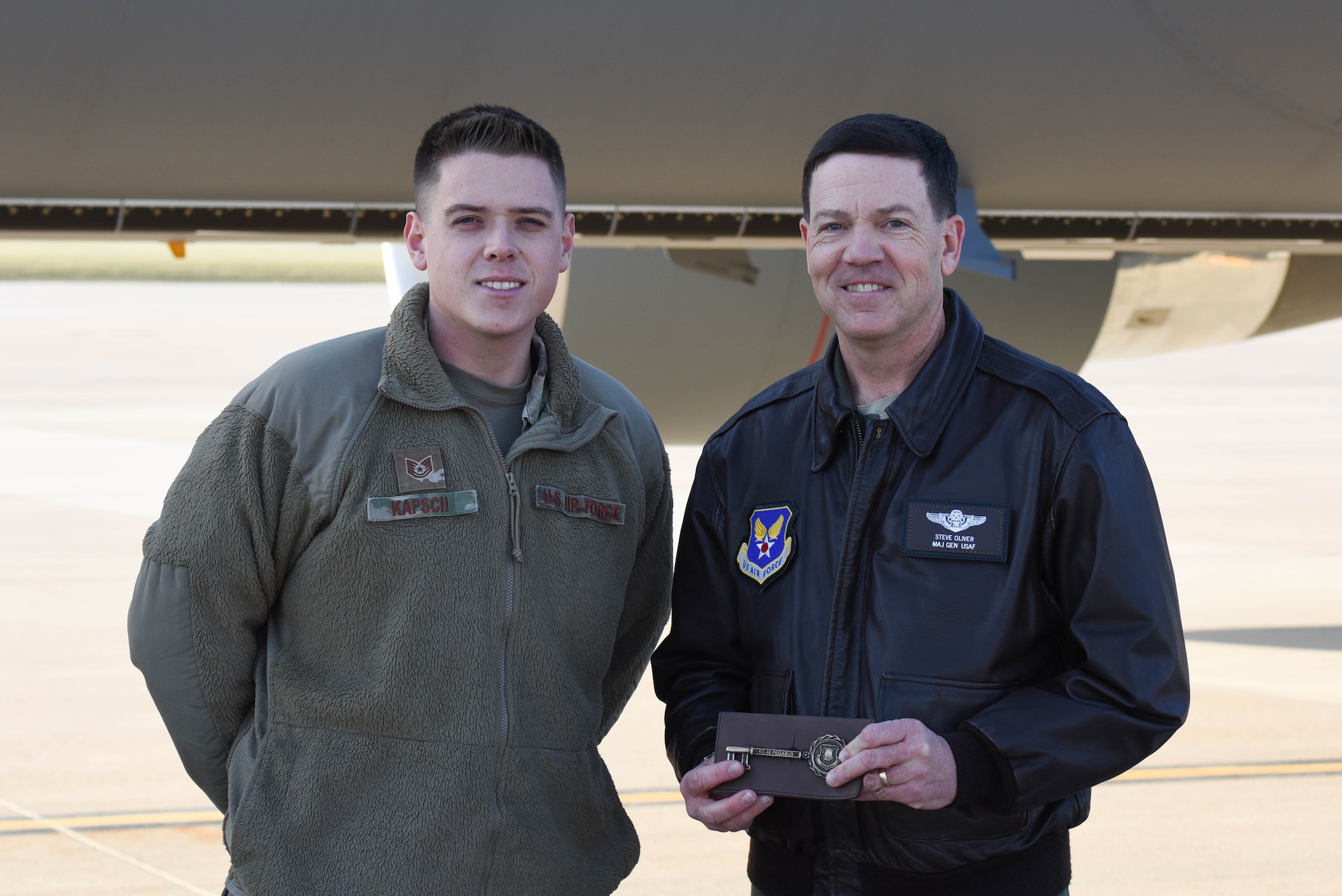 Maj. Gen. Stephen Oliver Jr., International Affairs assistant deputy under secretary of the Air Force, receives the aircraft key from Tech. Sgt. Justin Kapsch, 931st Aircraft Maintenance Squadron aerospace maintenance craftsman, Nov. 1, 2019, at McConnell Air Force Base, Kan. McConnell has now received 16 KC-46A Pegasus. (U.S. Air Force photo by Airman 1st Class Marc A. Garcia)