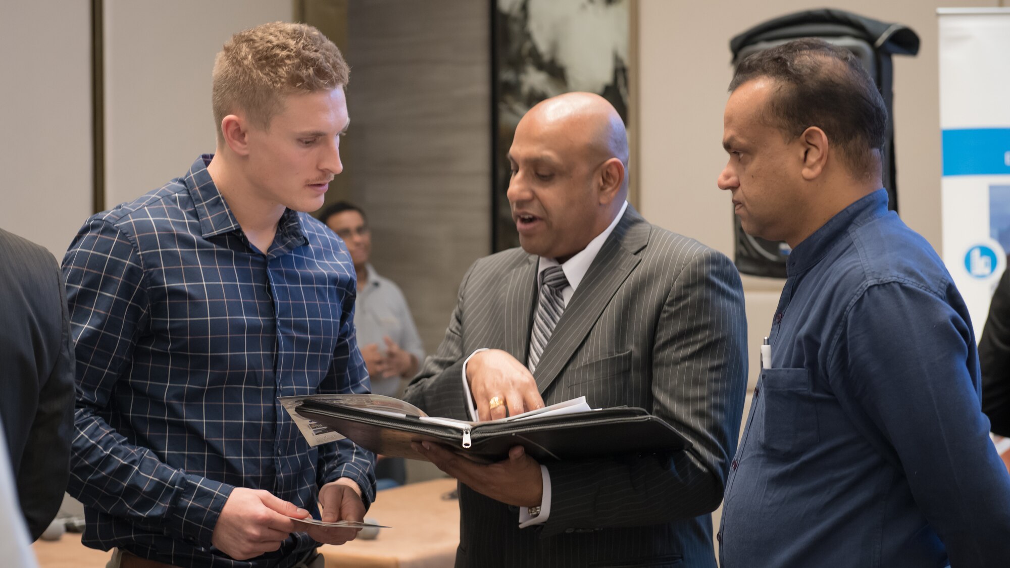 U.S. Air Force 1st Lt. Gavin McHenry, 386th Expeditionary Contracting Squadron base operations support flight commander and Air Force contract augmentation program administrative officer, speaks with local attendees at the Discover America week business speakers seminar at the Hyatt Regency Hotel in Kuwait City, Nov. 4, 2019. Airmen with the 386th ECONS discussed contract opportunities to local vendors. (U.S. Air Force photo by Tech. Sgt. Daniel Martinez)