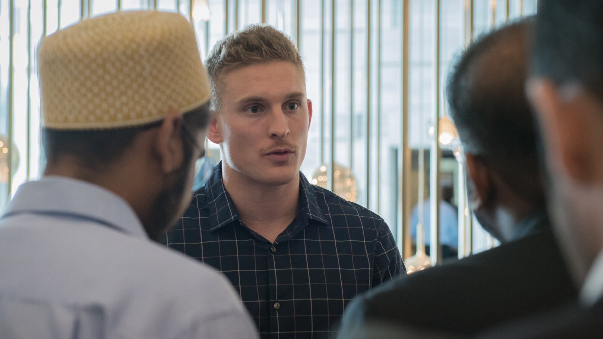 U.S. Air Force 1st Lt. Gavin McHenry, 386th Expeditionary Contracting Squadron base operations support flight commander and Air Force contract augmentation program administrative officer, speaks with local attendees at the Discover America week business speakers seminar at the Hyatt Regency Hotel in Kuwait City, Nov. 4, 2019. Airmen with the 386th ECONS discussed contract opportunities to local vendors. (U.S. Air Force photo by Tech. Sgt. Daniel Martinez)
