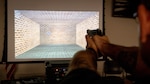 An Airman from the 139th Security Forces Squadron, Missouri Air National Guard, practices shooting on a weapon simulator at Rosecrans Air National Guard Base, St. Joseph, Missouri, Nov. 2, 2019. The squadron received the new weapon simulator to train and improve shooting skills. Every security forces unit in the Air National Guard will receive the simulator system.