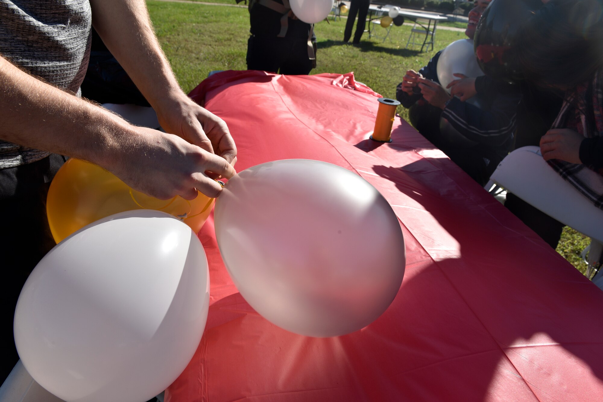 Zachary Mennona, Student Flight attendee with the 145th Airlift Wing, ties balloons together in anticipation of the Fall Festival put together by the Junior Enlisted Council (JEC) at the North Carolina Air National Guard (NCANG) Base, Charlotte Douglas International Airport, Nov. 2, 2019. The Fall Festival is a first-time event for the JEC and NCANG that is hoped to be held for years to come.