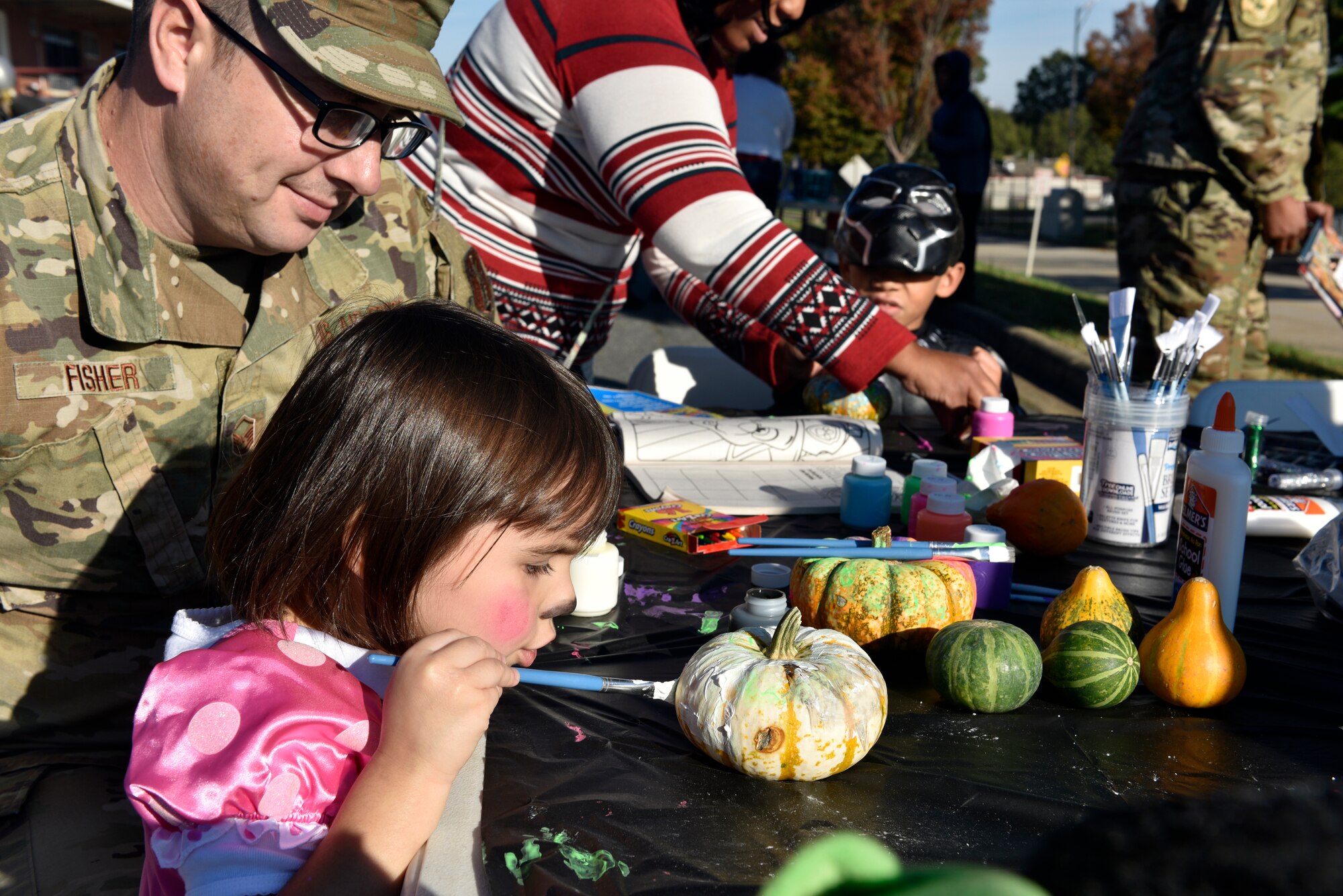 A young girl paints a pumpkin during a Fall Festival put together by the Junior Enlisted Council (JEC) at the North Carolina Air National Guard (NCANG) Base, Charlotte Douglas International Airport, Nov. 2, 2019. The Fall Festival is a first-time event for the JEC and NCANG that is hoped to be held for years to come.