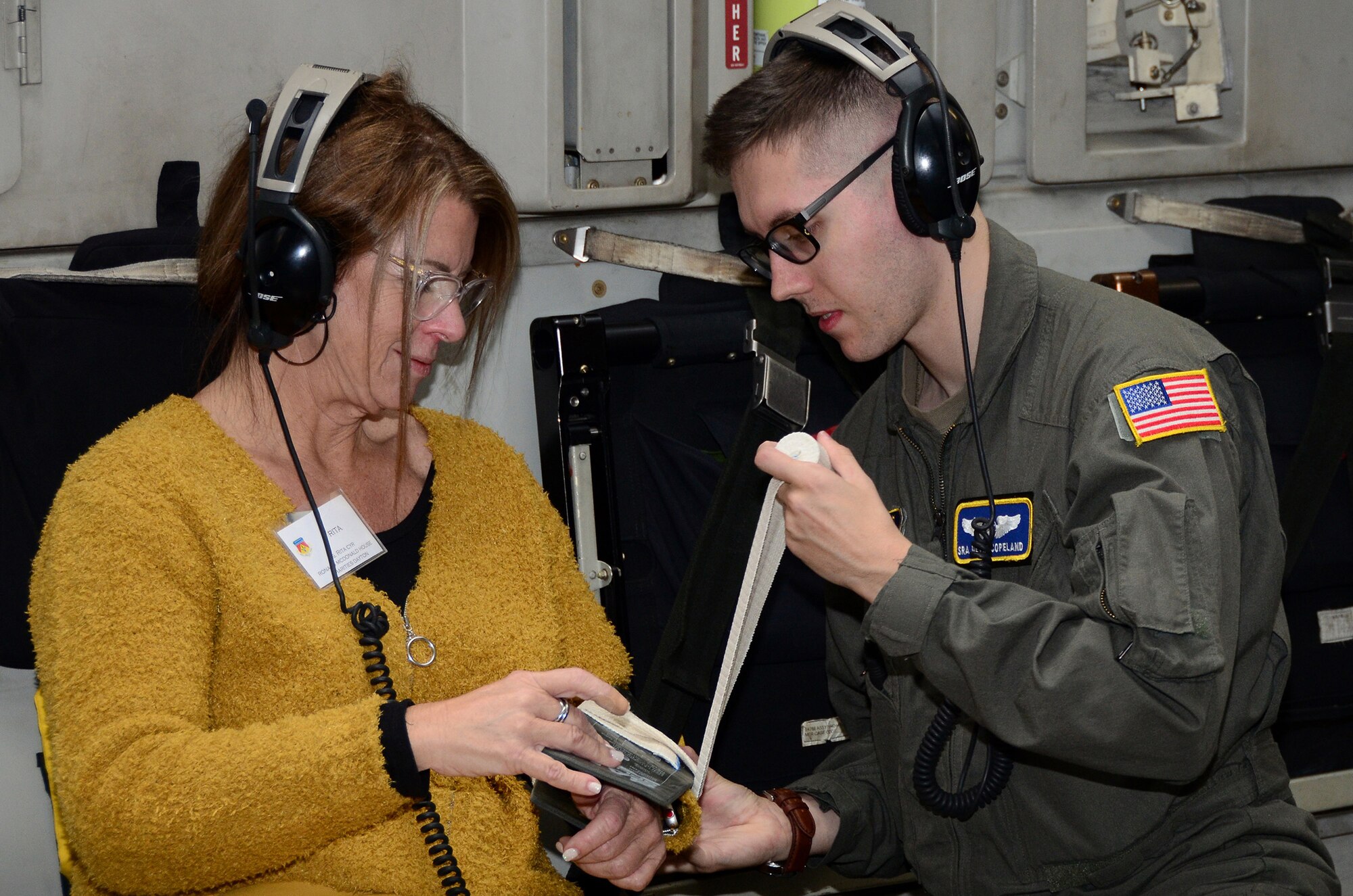 Senior Airman Devin Copeland, 445th Aeromedical Evacuation Squadron, puts a splint on volunteer Rita Cyr, CEO of Ronald McDonald House Charities Dayton, during a hands-on AES demonstration on board a 445th Airlift Wing C-17 Globemaster III during a civic leader tour flight to Colorado Springs Oct. 9, 2019. Nineteen Greater Dayton area civic leaders participated in a civic leader tour hosted by the 445th Airlift Wing Oct. 9-10 at both Peterson Air Force Base and the Air Force Academy in Colorado Springs, Colorado.