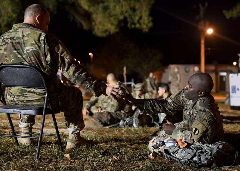 U.S. Army Soldiers share water after completing the Norwegian Foot March at Joint Base Langley-Eustis, Virginia, Oct. 30, 2019.