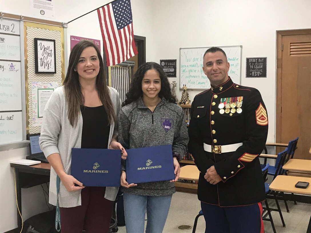 Staff Sgt. Andrew Portell, Staff Non-Commissioned Officer of Recruiting Substation St. Louis, recognizes Madison Blackmon and her mentor Jennifer Conway of Affton High school, for their achievements at the 2019 Battles Won 
Academy. Only 100 students nationwide are selected for the Marine Corps' prestigious Semper Fidelis All-American Program. The selected All-Americans attend the exclusive Battles Won Academy held during the summer, where they 
will meet and share stories with national leaders and influencers. Attendees will network with Marines, athletic leaders, industry leaders, national leaders, and leaders in innovative thinking, all of which will help them create opportunities that will accelerate their futures.