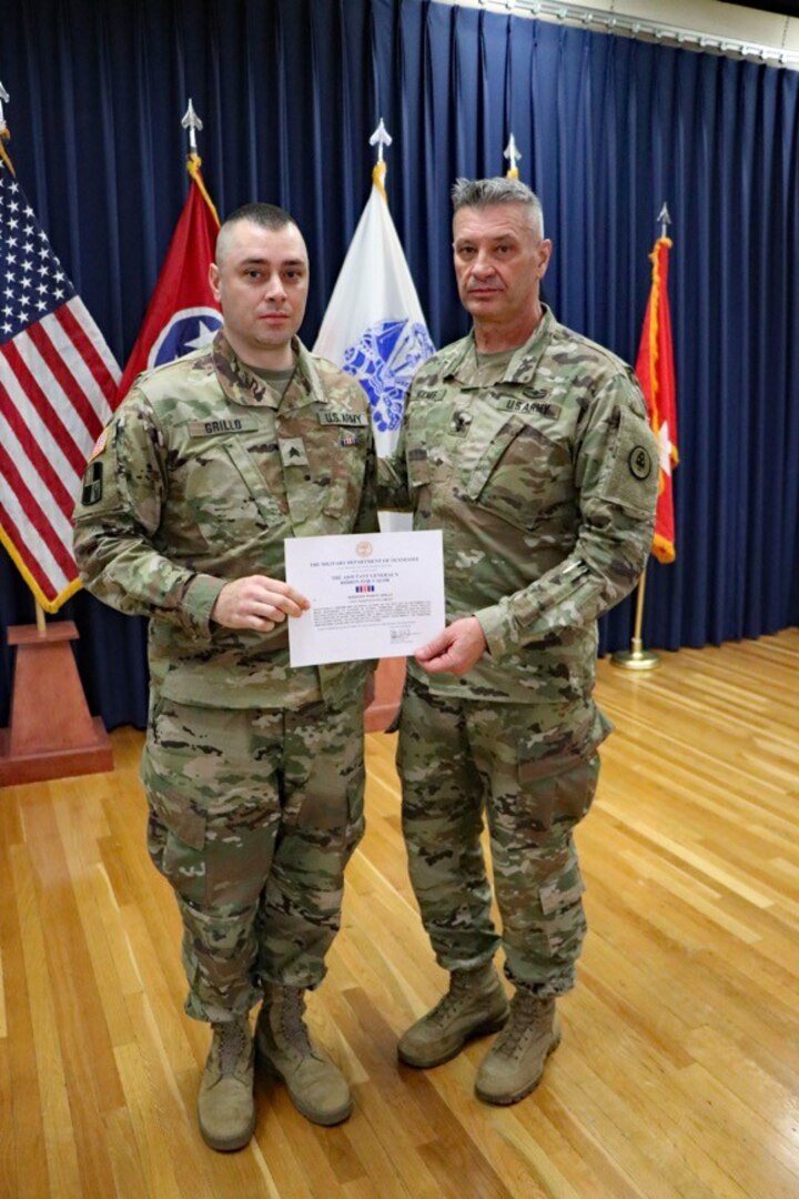 Maj. Gen. Jeff Holmes, Tennessee’s adjutant general, presents Sgt. Ryan Grillo, a Soldier with the 1176th Transportation Company, the adjutant general’s Ribbon for Valor on Nov. 2. Grillo and another citizen rescued two women and a small child from flood waters in Athens Sept. 26, 2018.