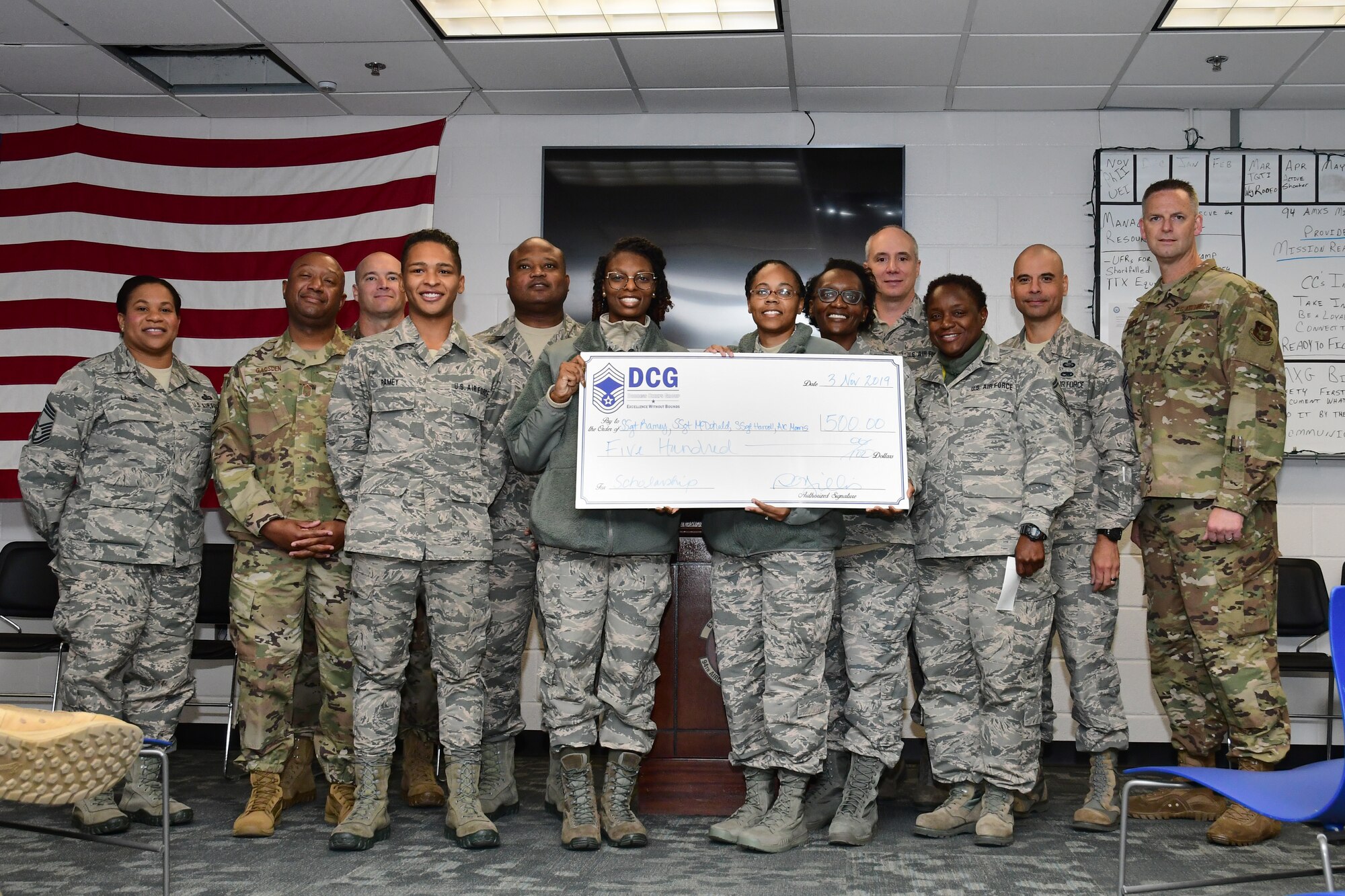 The Dobbins Chief Group Scholarship winners pose with the DCG during a ceremony held at Dobbins Air Reserve Base, Ga. on Nov. 4, 2019. Each winner received a check for $500 to be used towards school expenses. (U.S. Air Force photo/Tech. Sgt. Andrew Park)