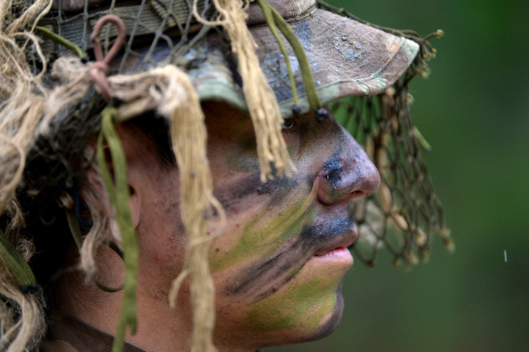 An Army Sniper School graduate prepares for a final challenge .