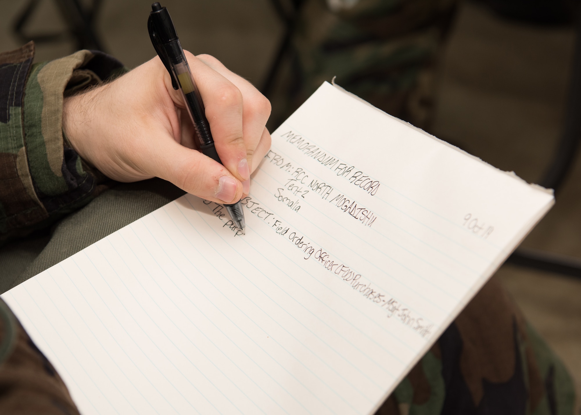 Senior Airman John Cone, a contracting administrator with the 509th Contracting Squadron, writes a memorandum during a mock deployment exercise, Oct. 9, 2019, at Whiteman Air Force Base, Missouri. Operation Pathfinder simulated sending two teams of nine contracting Airmen to establish a deployed base for 700 joint personnel in Mogadishu, Somalia. (U.S. Air Force photo by Airman 1st Class Parker J. McCauley)