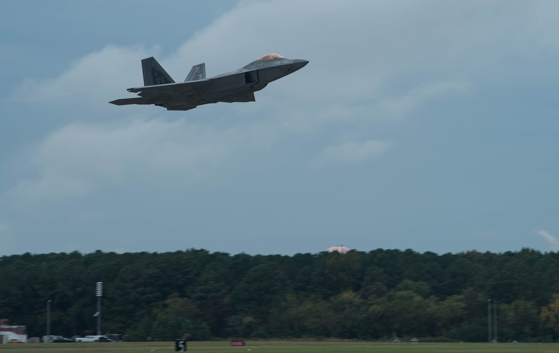 A U.S. Air Force F-22 Raptor takes off at Joint Base Langley-Eustis, Virginia, Oct. 31, 2019. The F-22 was involved in adversary air training with T-38A Talons. (U.S. Air Force photo by Airman 1st Class Sarah Dowe)