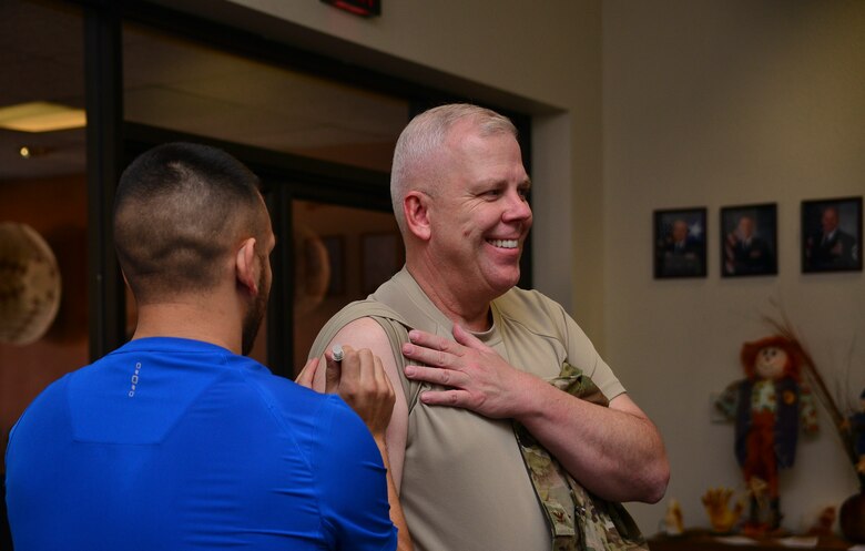 From left, a member of the 377th Medical Group administers an influenza vaccination to U.S. Air Force Col. Christopher J. King, 377th Air Base Wing vice commander, at Kirtland Air Force Base, N.M., Nov. 1, 2019. The flu shot is required annually by all service members. (U.S. Air Force photo by Staff Sgt. Kimberly Nagle)