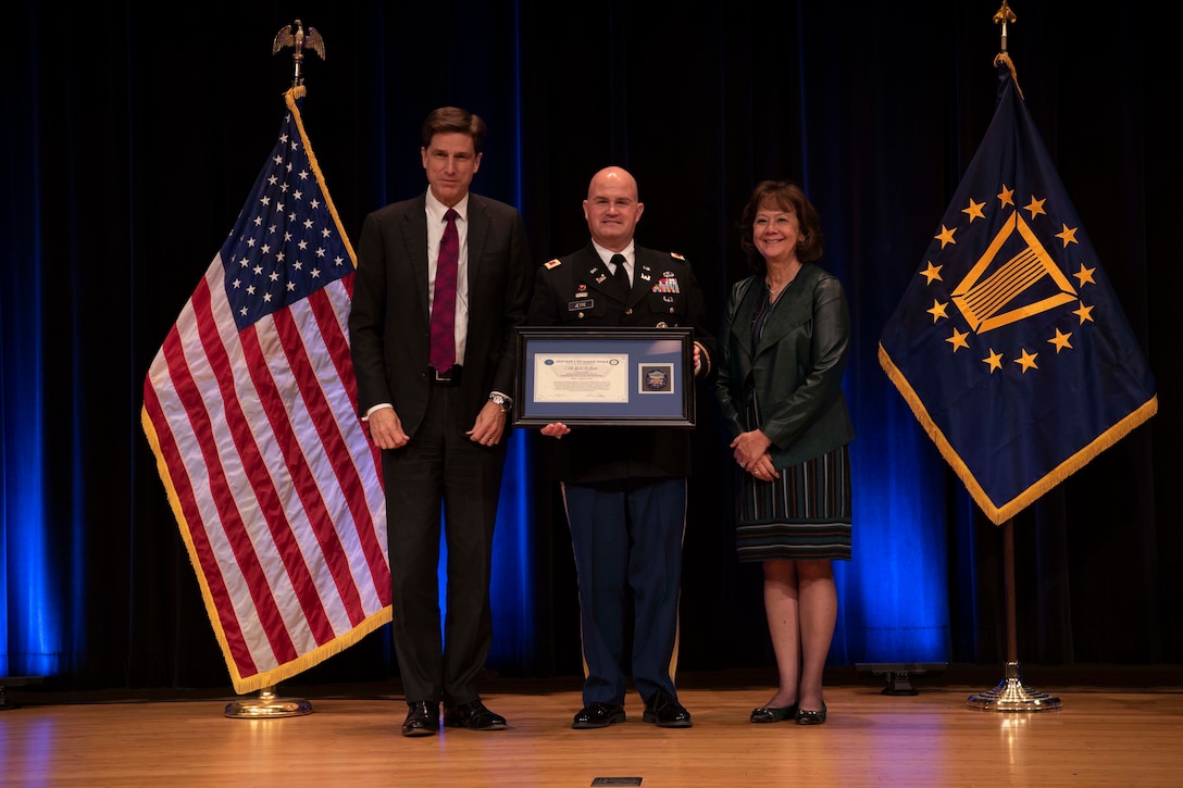 Army Col. Kyle F. Jette receives an award.