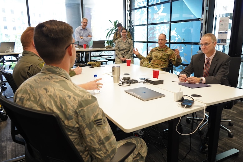 U.S. Air Force Maj. Rachel Ramirez, Senior Airman Jacob Traugott, Maj. Ivan Bohlender and Maj. Louis Bennett talk with Maj. Gen. Mark Weatherington, AETC deputy commander, about Project NEXUS before their graduation ceremony Nov. 4, 2019 at the Capital Factory in Austin, Texas. Designed by the AETC Integrated Technology Detachment and hosted by the AFWERX-Austin hub, the beta test program was designed to fuel organic technology problem solving efforts for Airmen in their day-to-day workplaces. (U.S. Air Force photo / Staff Sgt. Jordyn Fetter)