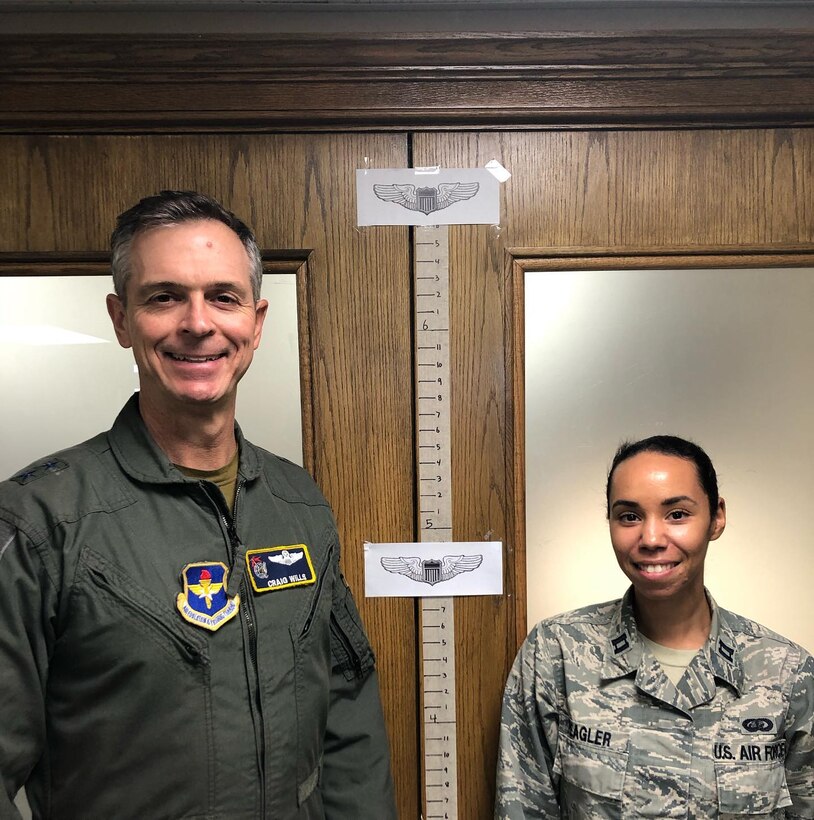 Maj. Gen. Craig Wills, 19th Air Force commander, stands side-by-side with a 19th Air Force pilot to illustrate the varying standing heights of Air Force pilots to dispel the myth that there is one height standard for all Air Force pilots.  Height waivers are available for candidates that do not meet AFI 48-123 standards. If you are interested in learning more about height waivers, work with your commission source or contact the Air Force Call Center at 1-800-423-USAF. (U.S. Air Force courtesy photo)