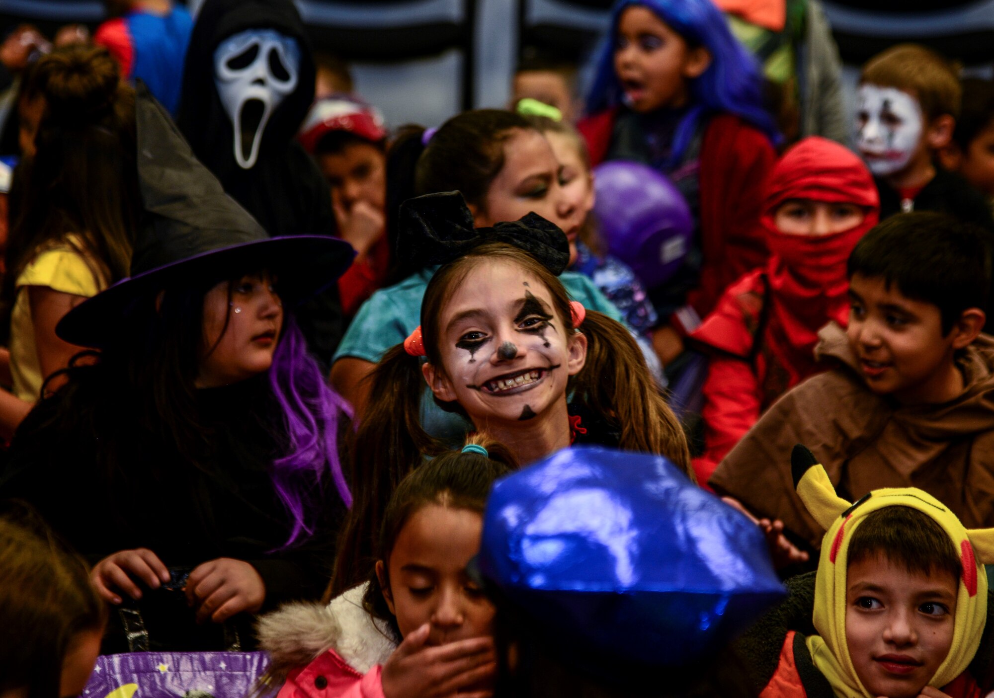 A Kirtland Elementary School student poses for a photo during a trick-or-treat event on Kirtland Air Force Base, N.M., Oct. 31, 2019. Each year, SMC invites the school to their Haunted Halloween event in which the entire building is filled with spooky decorations and hundreds of pounds of candy are passed out to costumed visitors.