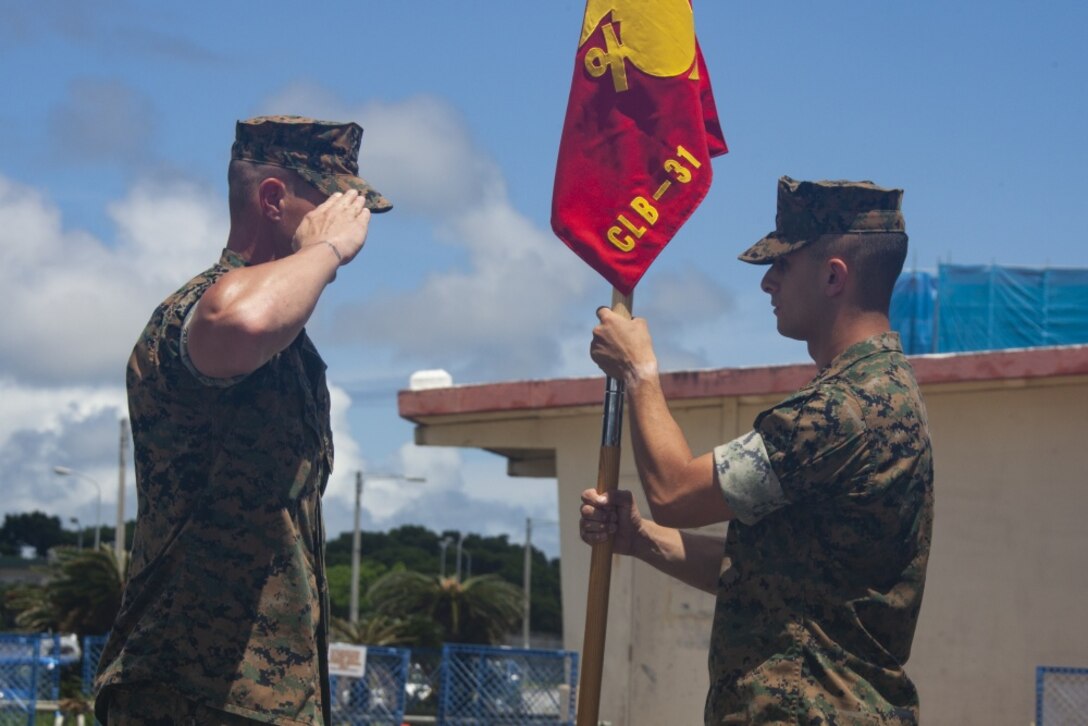 Gunnery Sgt. Jared McManus, company first sergeant for Maneuver Company, salutes 1st Lt. Sean Gunn, company commander of Maneuver Company, during the company activation ceremony at Camp Hansen, Okinawa, Japan, Aug. 30, 2019.