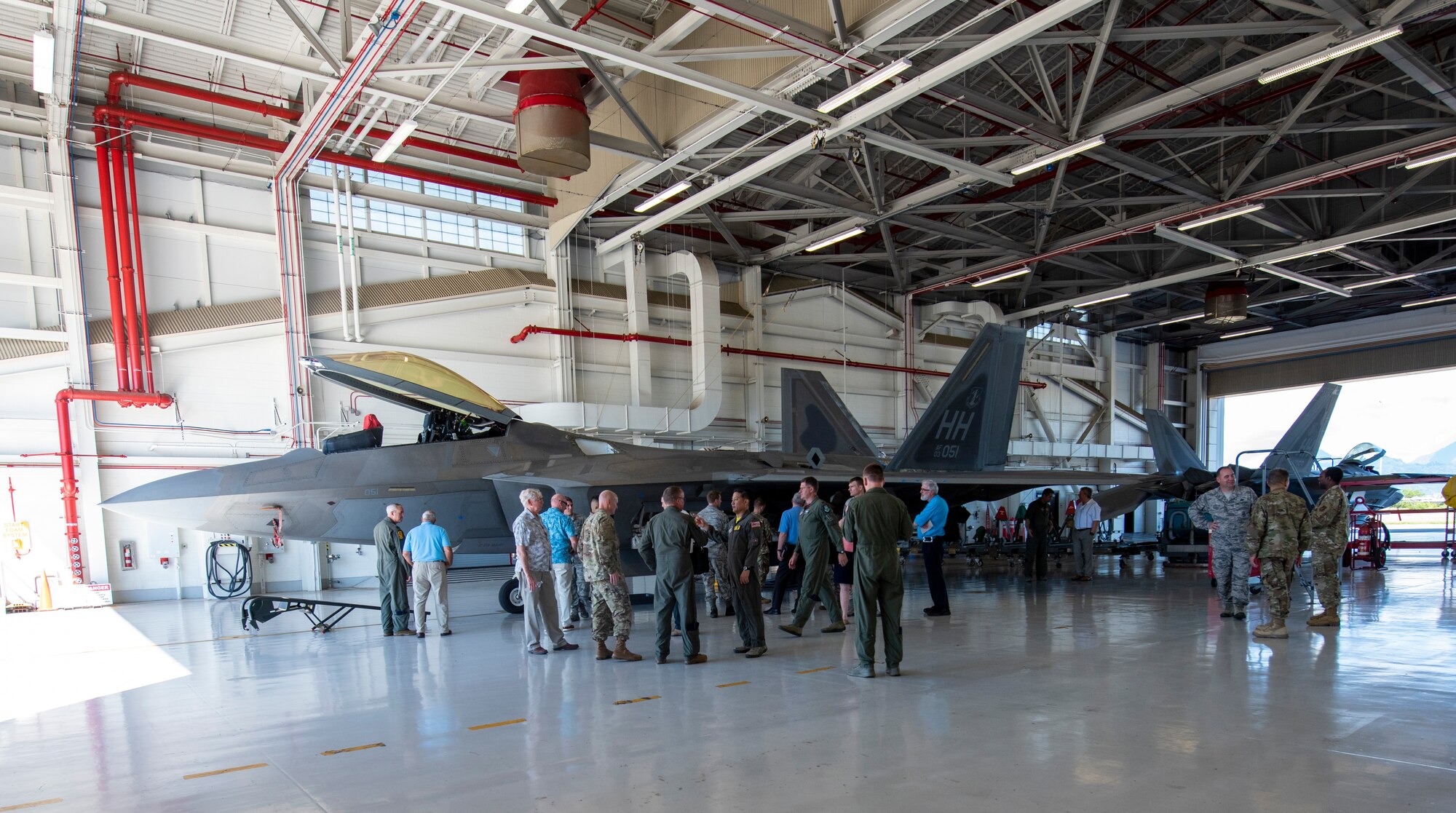 Members of the National Commission on Military Aviation Safety (NCMAS) take a tour of the F-22 Raptor facility Nov. 1, 2019, at Joint Base Pearl Harbor-Hickam. The purpose of NCMAS is to examine past mishaps and make recommendations to the President, Congress and ultimately the Defense Department on ways to improve aviation safety and readiness in the military. As part of their review, members of NCMAS conducted site visits of various flight facilities and operations located on Oahu island. (U.S. Air National Guard photo by Tech. Sgt. Alison Bruce-Maldonado)