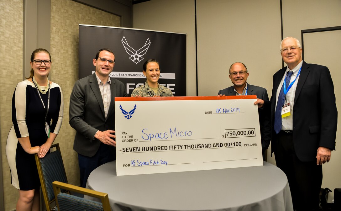 Dr. William Roper, Assistant Secretary of the Air Force for Acquisition, presents the first giant check of $750,000 at Air Force Space Pitch Day, Nov. 5, 2019, San Francisco, Calif. Air Force Space Pitch Day is a two-day event hosted by the Air Force to demonstrate the Air Force’s willingness and ability to work with non-traditional startups. (U.S. Air Force photo by Van De Ha)