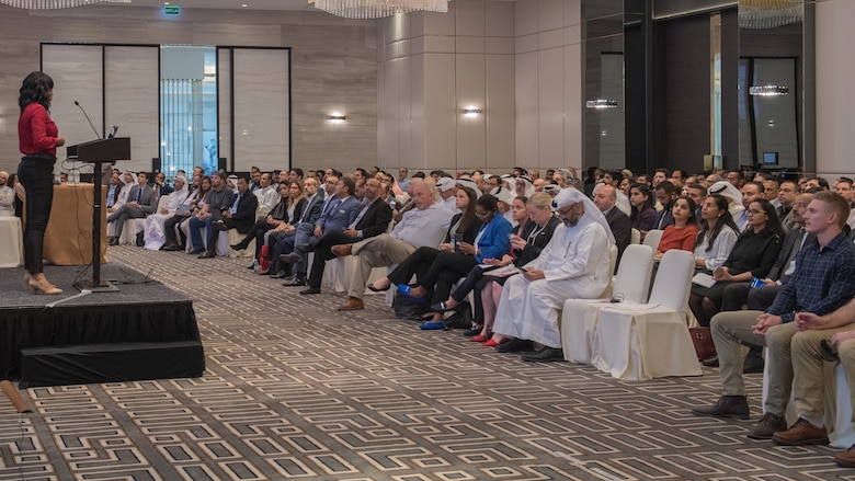 Senior Airman Kadijah Hill, 386th Expeditionary Contracting Squadron contingency contracting officer, speaks to attendees during the Discover America week business speakers seminar at the Hyatt Regency Hotel in Kuwait City, Nov. 4, 2019. Airmen with the 386th ECONS discussed contract opportunities to local vendors. (U.S. Air Force photo by Tech. Sgt. Daniel Martinez)