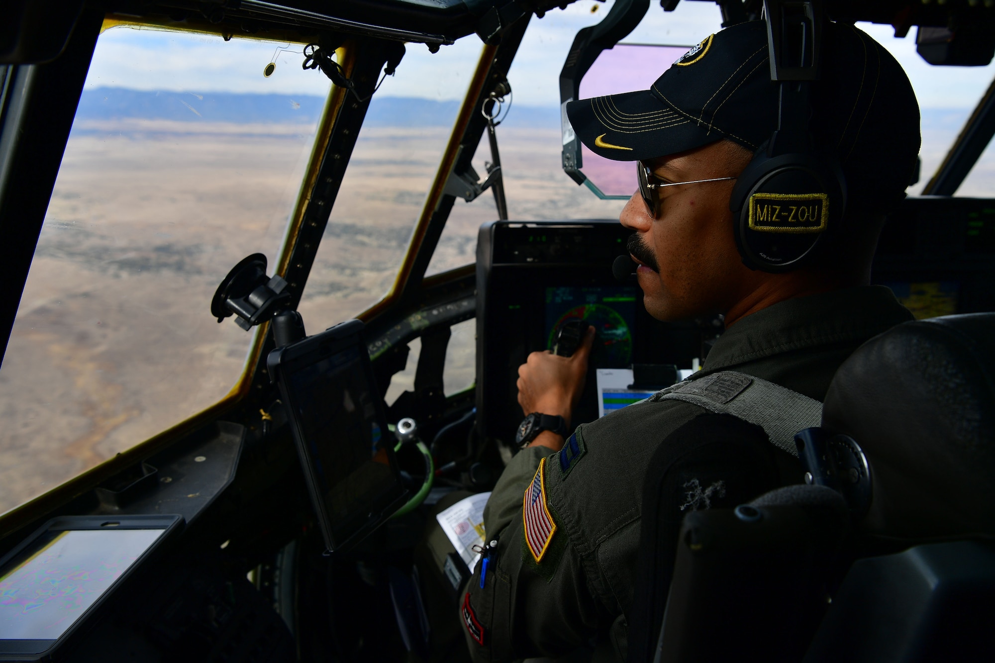 A student pilot looks out the window of a C-130 Hercules.