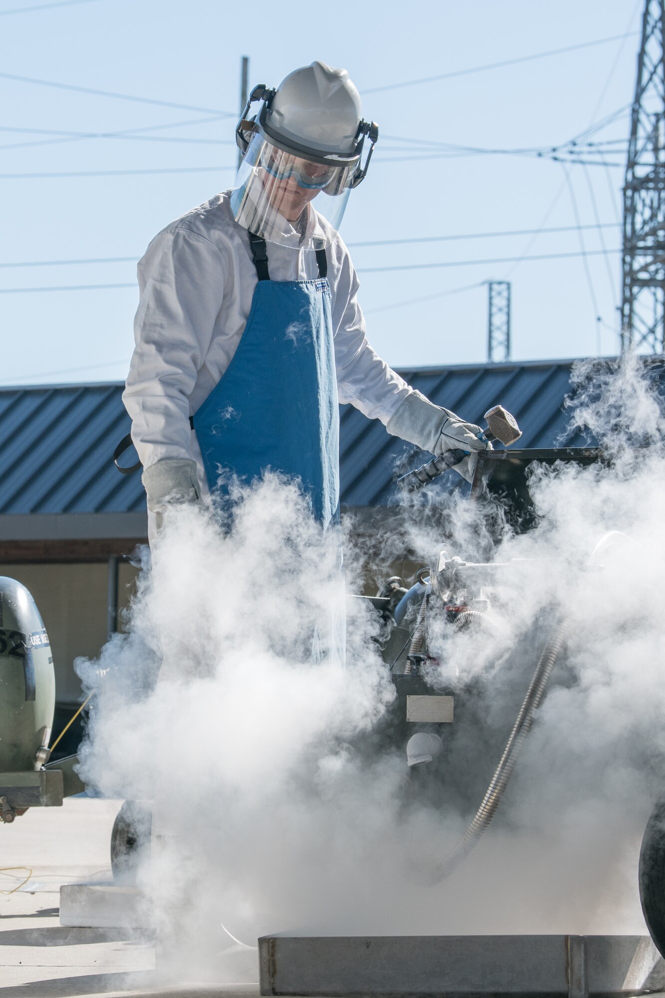 Airman 1st Class Justin Jett, fuels distribution operator, 436th Logistics Readiness Squadron, fills transfer carts with liquid oxygen, Nov. 4, 2019, at Dover Air Force Base, Del. The liquid oxygen will be loaded onto aircraft, where it is converted back to a breathable gaseous form for the aircrews. (U.S. Air Force photo by Mauricio Campino)