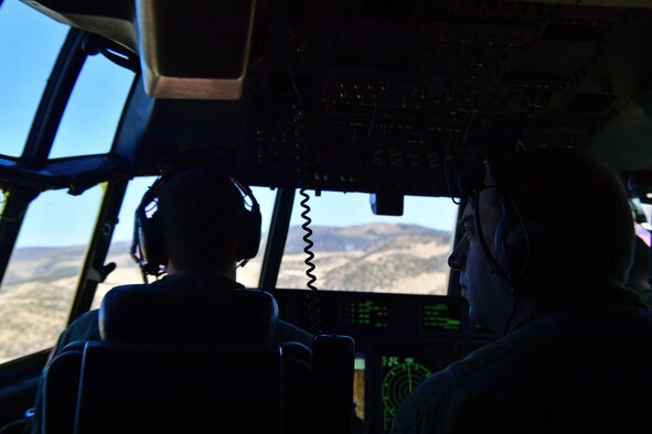 An instructor observes and records how a student pilot responds to complex training situations over Colorado.