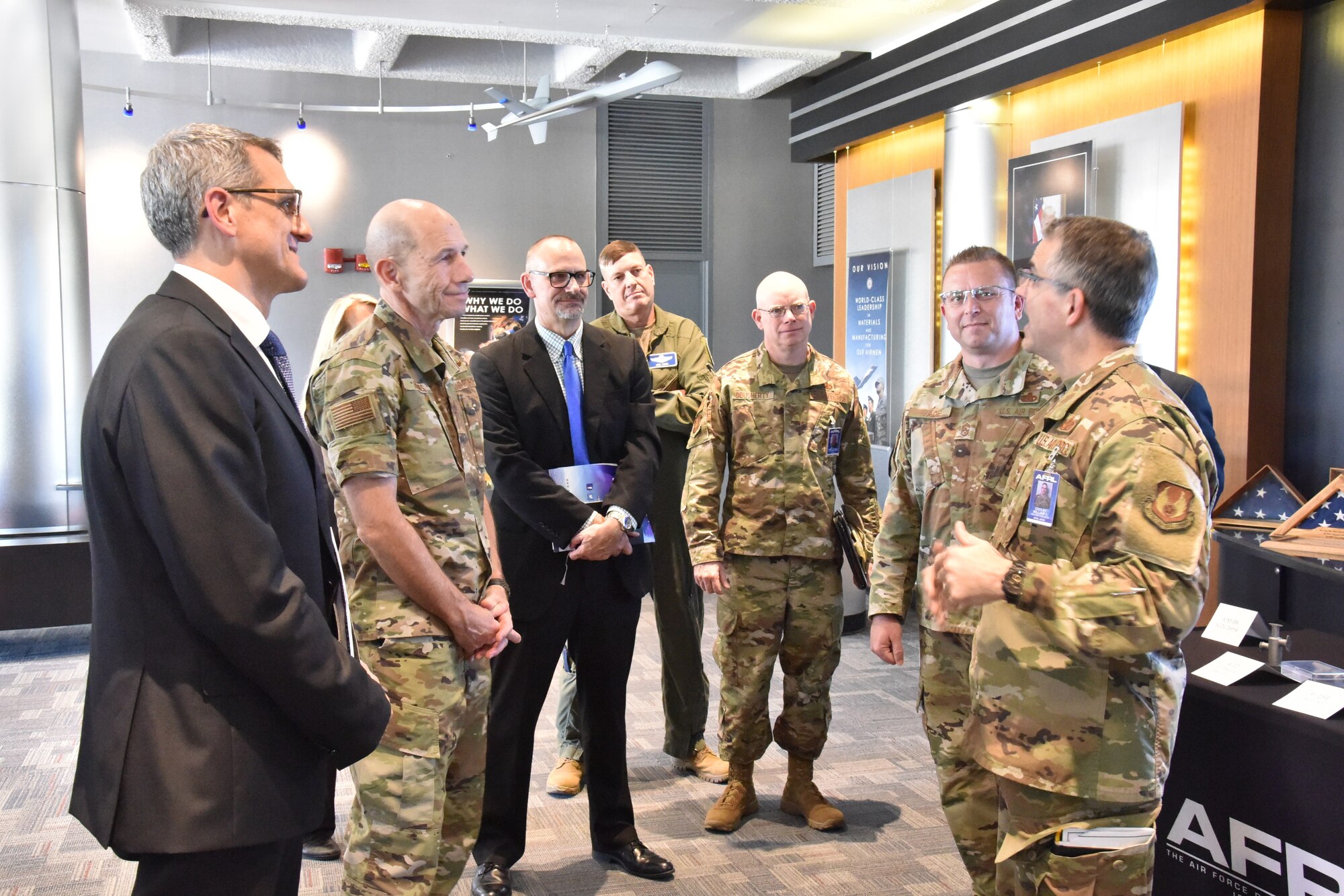 Maj. Gen. William Cooley, AFRL commander (right), and Timothy Sakulich, AFRL Materials and Manufacturing Director (left), join other AFRL officials in welcoming Gen. James M. “Mike” Holmes, Air Combat Command commander during his recent visit to the Materials and Manufacturing Directorate. (U.S. Air Force photo/Spencer Deer)