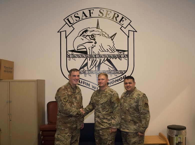 U.S. Air Force Brig. Gen. Mark August, 86th Airlift Wing commander, poses for a photo with U.S. Air Force Staff Sgt. Christian Martin, 86th Operation Support Squadron Survival, Evasion, Resistance, and Escape Training non-commissioned officer in charge, in recognition of Martin receiving Airlifter of the Week Oct. 31, 2019, on Ramstein Air Base, Germany. Martin maintains just under $1 million worth of facilities and training equipment in order to sustain aircrew currencies for missions spanning three geographic combatant commands.