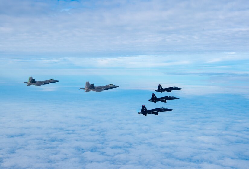 U.S. Air Force F-22 Raptors and U.S. Air Force T-38 Talons from the 1st Fighter Wing fly in formation of the Atlantic Ocean during training off the coast of Virginia, Oct. 30, 2019. The 1st Fighter Wing is home to the 94th Fighter Squadron, 27th Fighter Squadron and the 71st Fighter Training Squadron at Joint Base Langley-Eustis, Va. (U.S. Air Force Photo by Tech Sgt. Carlin Leslie)(Released)