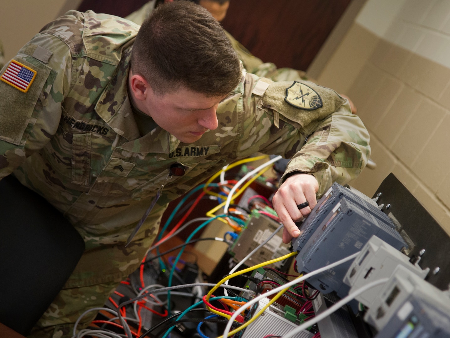 Staff Sgt. Matthew Hendricks of Maryland National Guard’s 169th Cyber Protection Team inspects a machine during a hands-on exercise while attending Cyber Shield 19 at Camp Atterbury, Ind., April 11, 2019. Military personnel work closely with interagency partners and the private sector to strengthen cybersecurity.