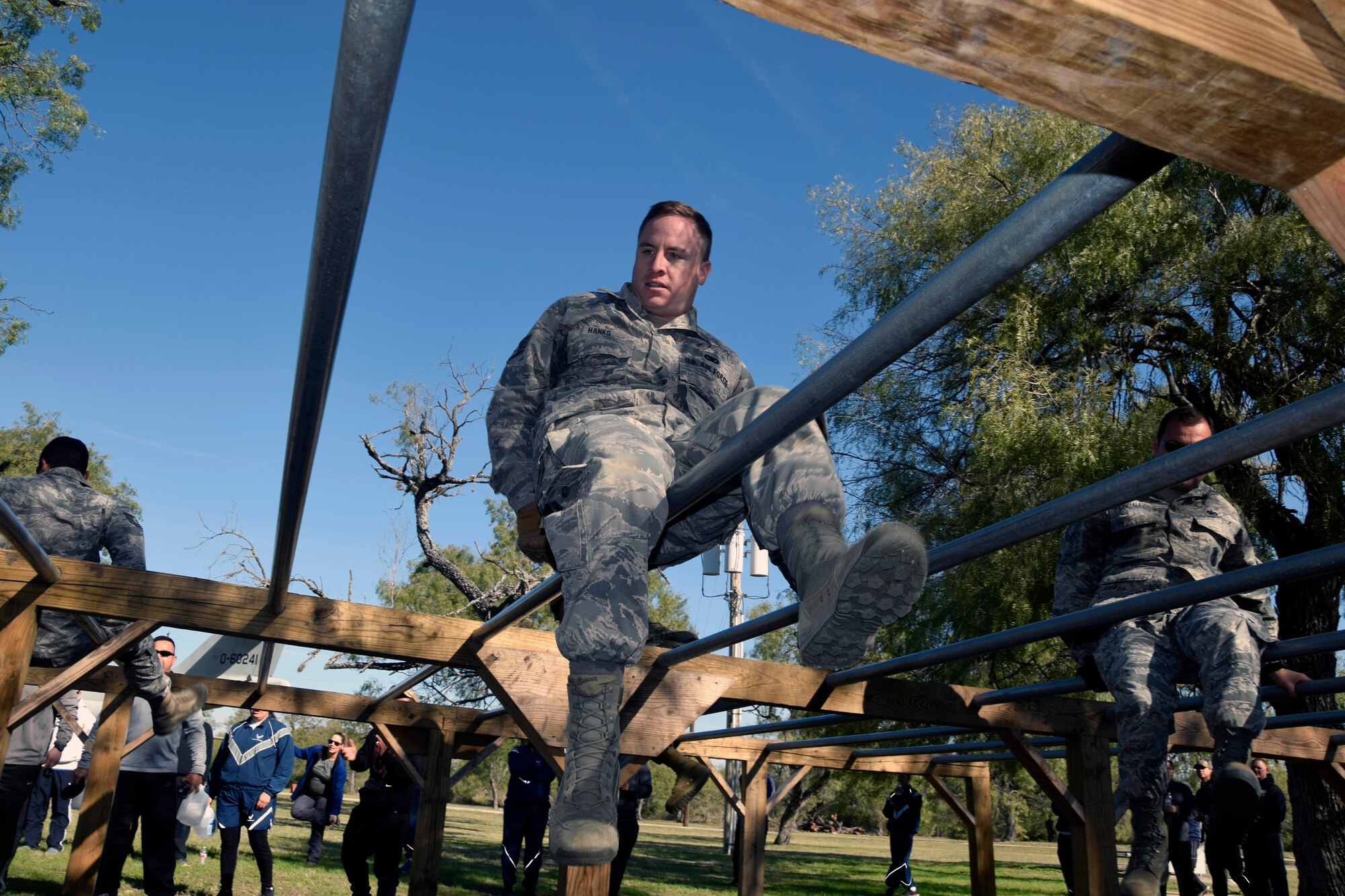 Staff Sgt. Bradley A. Hanks, 433rd Security Forces Squadron, crawls across an obstacle during a team-building exercise at the 433rd AW Resilience Tactical Pause at the Air Force Basic Military Training’s Basic Expeditionary Airman Skills Training site at the Medina Annex, Joint Base San Antonio-Lackland, Texas Nov. 3, 2019.