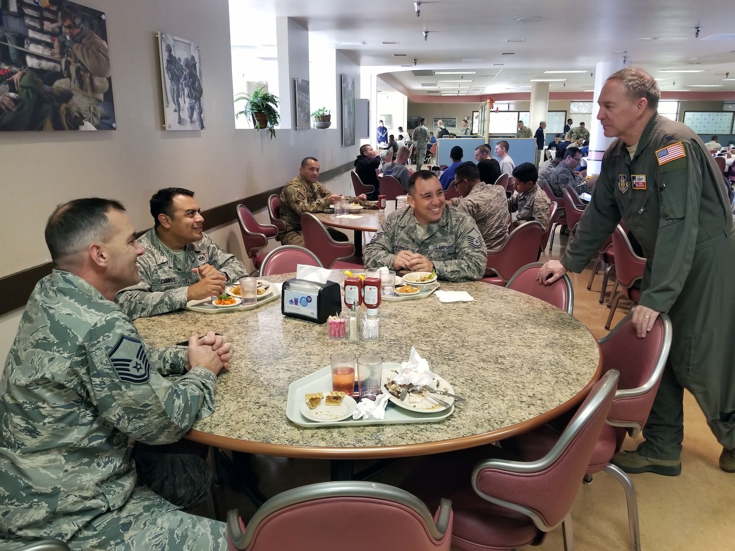 Col. Terry W. McClain, 433rd Airlift Wing commander, visits with Reserve Citizen Airmen after serving the Airmen a Thanksgiving feast at the Live Oak Dining Facility, Joint Base San Antonio-Lackland, Texas Nov. 2, 2019.