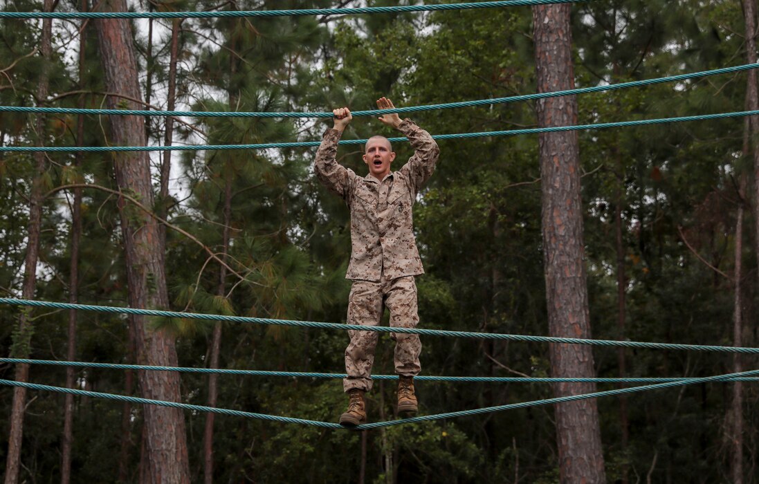 A recruit with Lima Company, 3rd Recruit Training Battalion, uses a rope to cross over a water obstacle on the Confidence Course on Marine Corps Recruit Depot Parris Island, S.C. Oct. 30, 2019. The Confidence Course is composed of various obstacles that both physically and mentally challenge recruits. (U.S. Marine Corps photo by LCpl. Michelle Brudnicki)